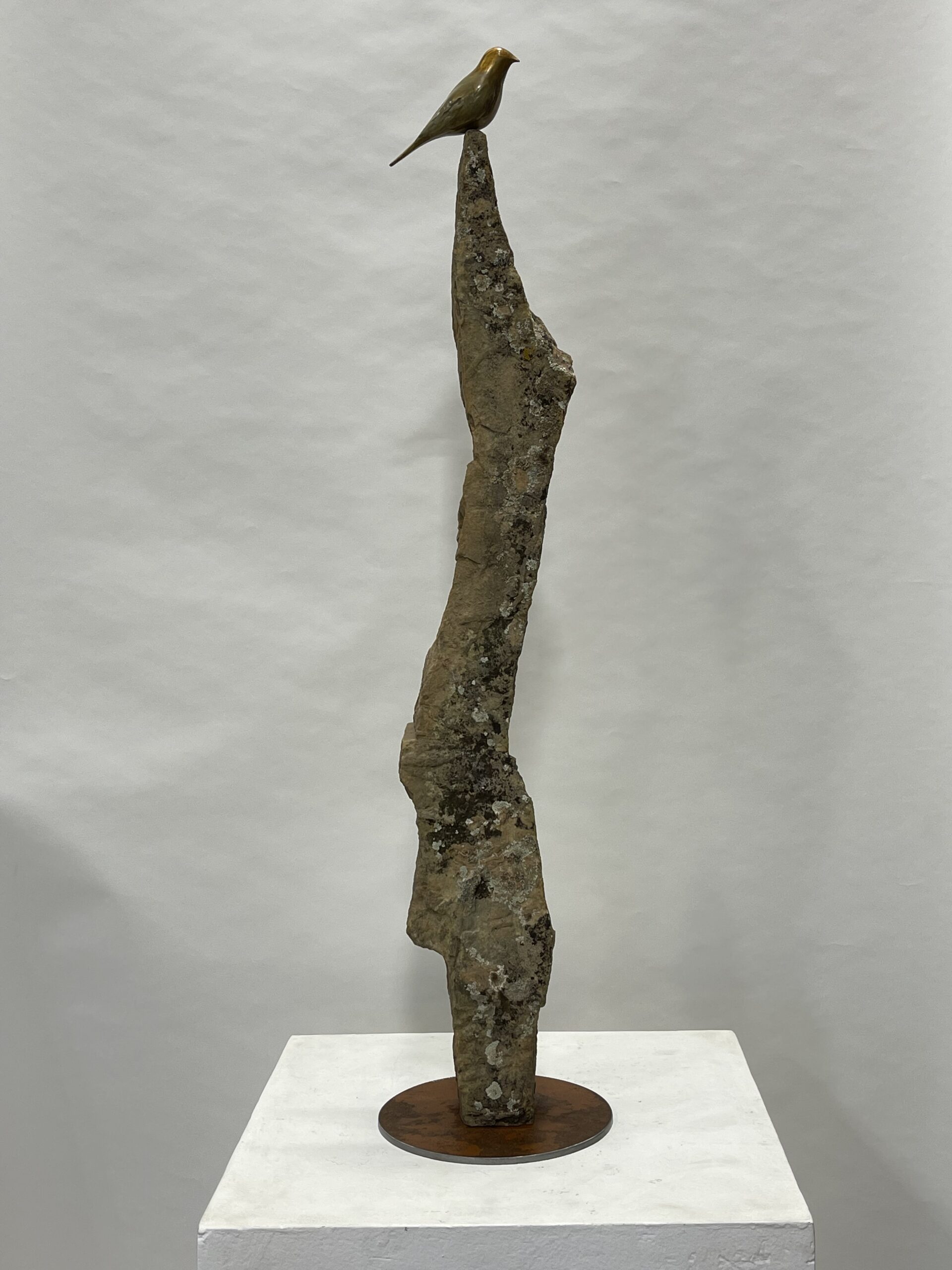 stone with bronze bird on top